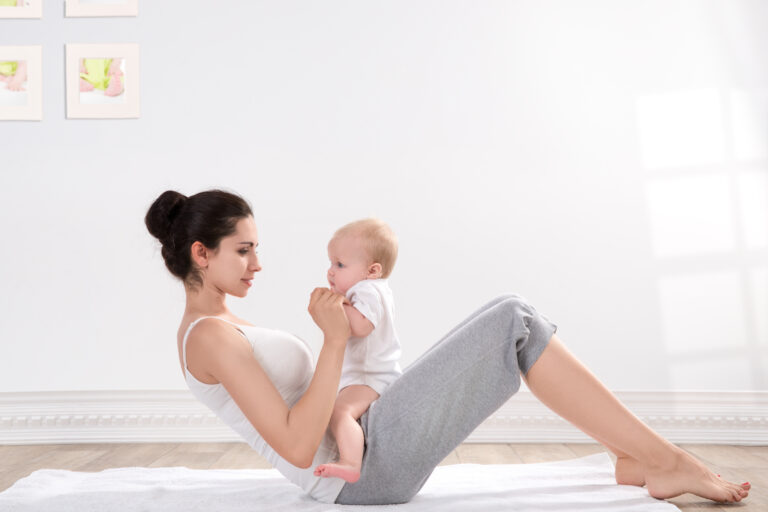 Photo of a young mother doing pelvic floor treatment exercises with an infant on her