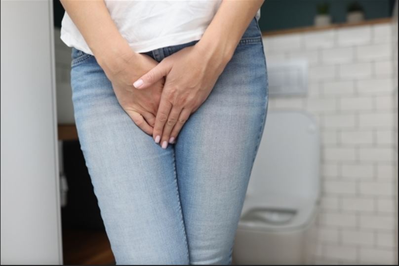 picture of a woman struggling with urinary incontinence caused by Pelvic Floor Dysfunction